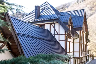 an image of a house with a blue roof at Hotel Apostolite in Sandanski