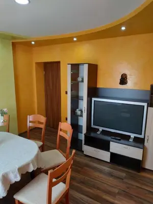 a living room with a television and a table and chairs at ВИЙГ in Sapareva Banya