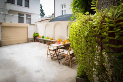 a patio with a table and chairs next to a building at The Rocky House - Central & Private 2BDR by Flat Mаnager in Plovdiv