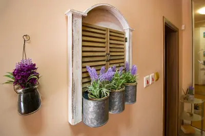 a mirror with three potted plants on a wall at The Rocky House - Central & Private 2BDR by Flat Mаnager in Plovdiv