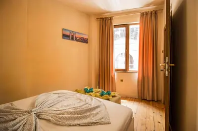 a bedroom with a bed and a window at The Rocky House - Central & Private 2BDR by Flat Mаnager in Plovdiv