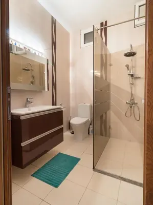 a bathroom with a toilet and a sink and a shower at The Rocky House - Central & Private 2BDR by Flat Mаnager in Plovdiv