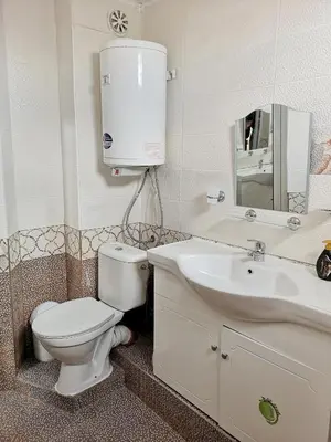 a bathroom with a white toilet and a sink at Merilyn Petrich in Petrich