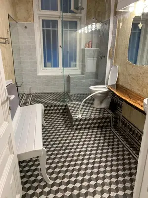 a bathroom with a shower and a toilet and a bench at 4us - 24h Self Check-in in Sofia