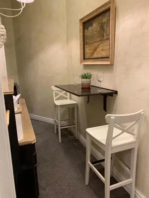 a table with two chairs and a table with a plant on it at 4us - 24h Self Check-in in Sofia