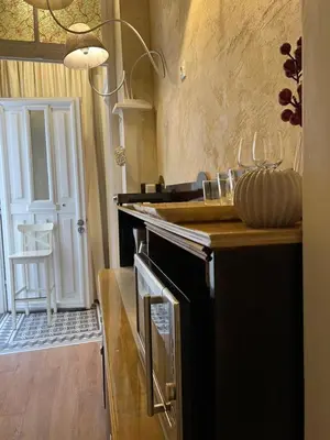 a kitchen with an oven and a counter with a table at 4us - 24h Self Check-in in Sofia