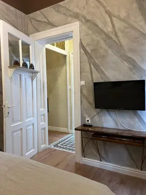 a bedroom with a flat screen tv on a wall at 4us - 24h Self Check-in in Sofia