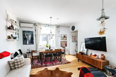 a living room with a couch and a dining room at 3BDR The Hadjis - City Center Flat in Sofia