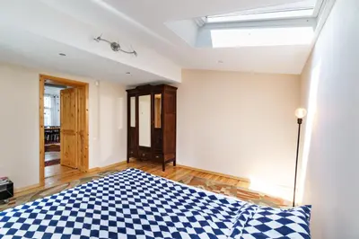 a bedroom with a blue and white checkered bed at 3BDR The Hadjis - City Center Flat in Sofia