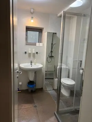 a bathroom with a sink and a toilet and a shower at Lilia 4 Self-Check in apartment in Sofia