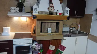a small kitchen with a stove and a sink at Holiday guest house KEMO in Sapareva Banya