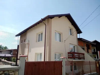 a house with a fence in front of it at Holiday guest house KEMO in Sapareva Banya