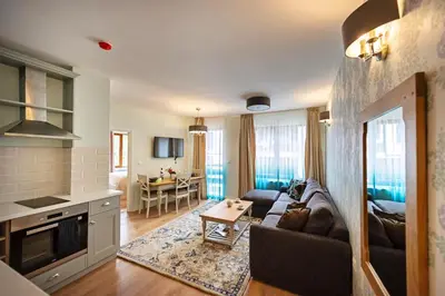 a living room with a couch and a table at Predela LUX Aparthotel in Bansko