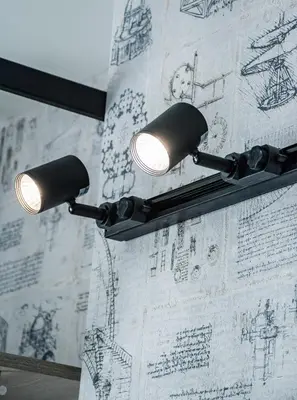 a couple of lights hanging on a wall with a drawing at A&M Hotel with free parking in Plovdiv