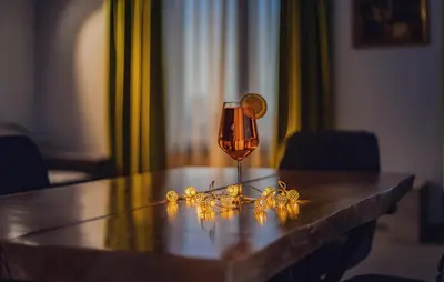 a glass of wine sitting on top of a table at A&M Hotel with free parking in Plovdiv