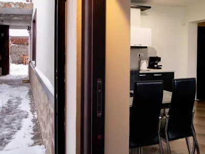 a room with a table and chairs in a kitchen at Relax in Dobrinishte