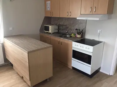 a kitchen with a white stove and a microwave at Комплекс Кали, к.к. Цигов Чарк in Tsigov Chark