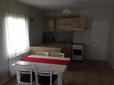 a kitchen with a red and white table and chairs at Комплекс Кали, к.к. Цигов Чарк in Tsigov Chark
