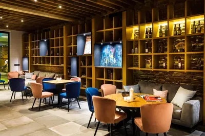 a restaurant with tables and chairs and a wall of shelves at Chateau Copsa Complex in Moskovets