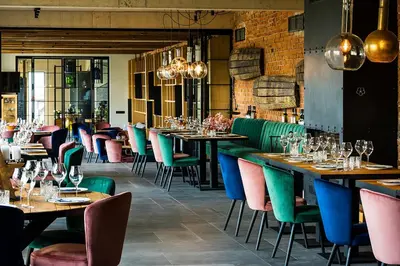a restaurant with tables and chairs with wine glasses at Chateau Copsa Complex in Moskovets