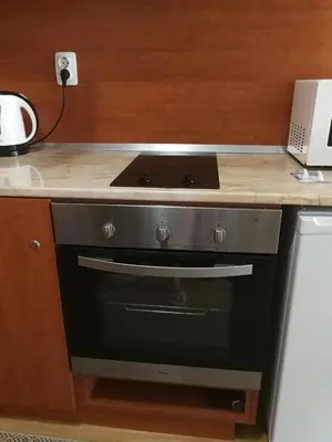 a stove top oven in a kitchen with a counter at G-Apartment, New Inn, 2-rooms in Bansko