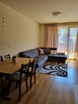 a living room with a couch and a table at G-Apartment, New Inn, 2-rooms in Bansko