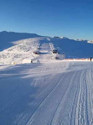 a snow covered slope with tracks in the snow at Iglika 2, V9 in Borovets