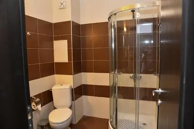 a bathroom with a toilet and a glass shower at Iglika 2, V9 in Borovets