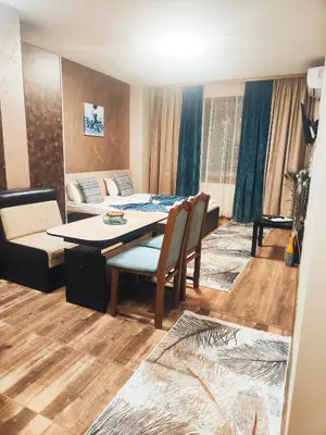 a living room with a table and a couch at Madini apartment in Velingrad