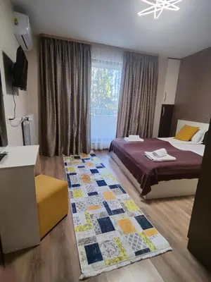 a bedroom with a bed and a rug at Madini apartment in Velingrad