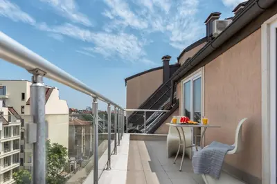 a balcony with a table and chairs on a building at Studio Talisman in Sofia