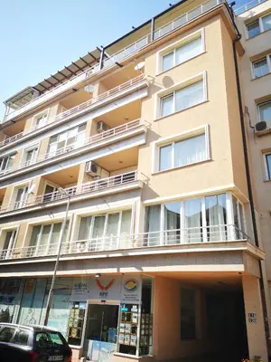 a large tan building with a balcony at Studio Talisman in Sofia