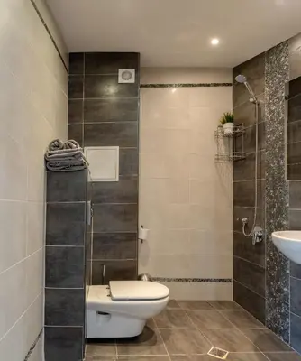 a bathroom with a toilet and a sink and a shower at Studio Talisman in Sofia