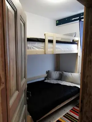 two bunk beds in a room with a window at EskiZ - Our stone home in Chepelare