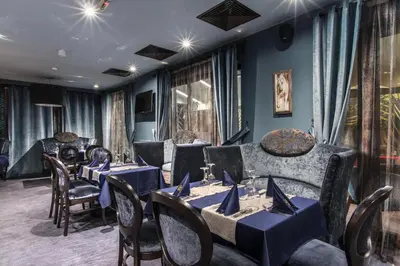 a dining room with blue tables and chairs at Ores Boutique Hotel in Bansko