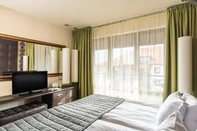 a bedroom with a large bed and a window at Ores Boutique Hotel in Bansko