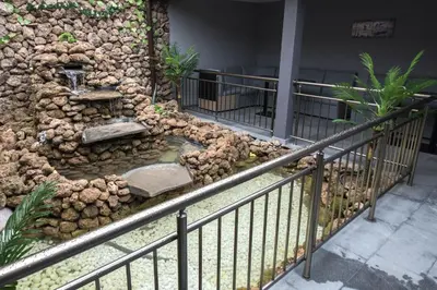 a stone wall with a water fountain on the side of a building at Etobicoke -Стаи за гости in Etropole