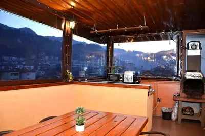 a table in a room with a view of a city at Стаи за Гости Тони и Крис in Devin