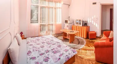 a bedroom with a bed and a table in a room at Sofia Apartment in House 8 boulevard Hristo Botev in Sofia