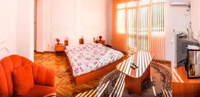 a bedroom with a bed and a chair and a tv at Sofia Apartment in House 8 boulevard Hristo Botev in Sofia