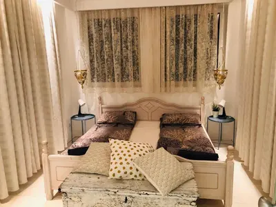 a bedroom with two beds and two lamps and curtains at Golden Pearl - jacuzzi top center luxury apartment in Sofia