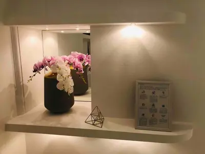a room with two vases with flowers on a shelf at Golden Pearl - jacuzzi top center luxury apartment in Sofia
