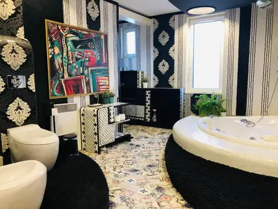 a bathroom with a tub and a toilet and a sink at Golden Pearl - jacuzzi top center luxury apartment in Sofia