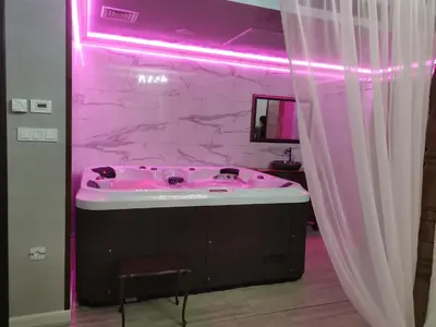 a pink bathroom with a tub with a pink lighting at Възрожденски комплекс Чардакъ Сопот in Sopot