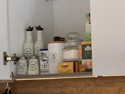 a shelf with milk bottles and other items on it at ViITOSHKA Apartment in Sofia
