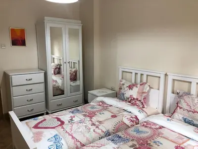a bedroom with two beds and a dresser at ViITOSHKA Apartment in Sofia
