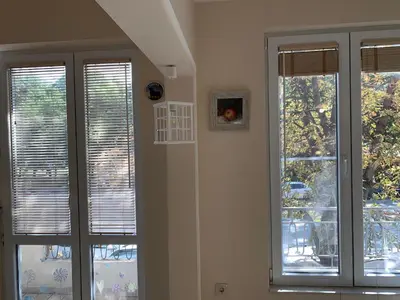 a room with three windows with blinds on them at ViITOSHKA Apartment in Sofia