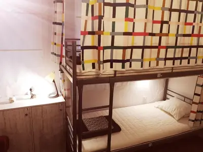 a bedroom with a bunk bed with a lamp and a desk at PIJAMA HOUSE - Bike & Bed in Plovdiv