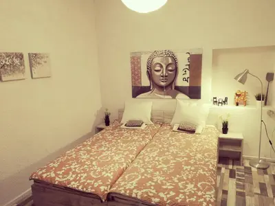 a bedroom with a bed with a statue of a head at PIJAMA HOUSE - Bike & Bed in Plovdiv