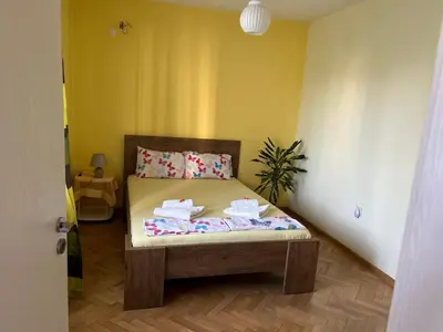 a bedroom with a bed in a room at Апартаменти Уют in Plovdiv